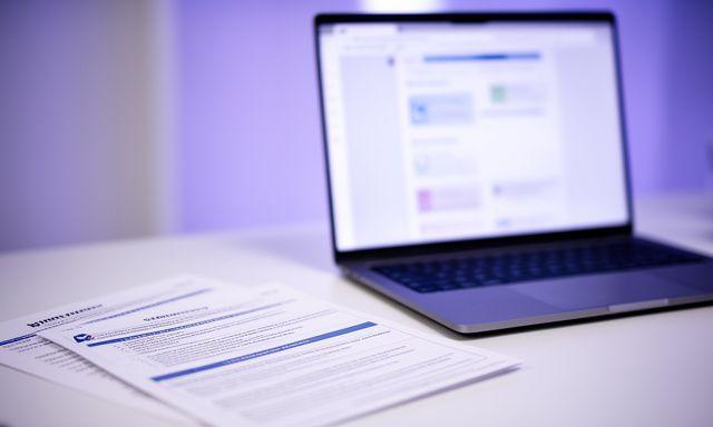 Workspace screen showing SaaS compliance notes beside printed privacy documents